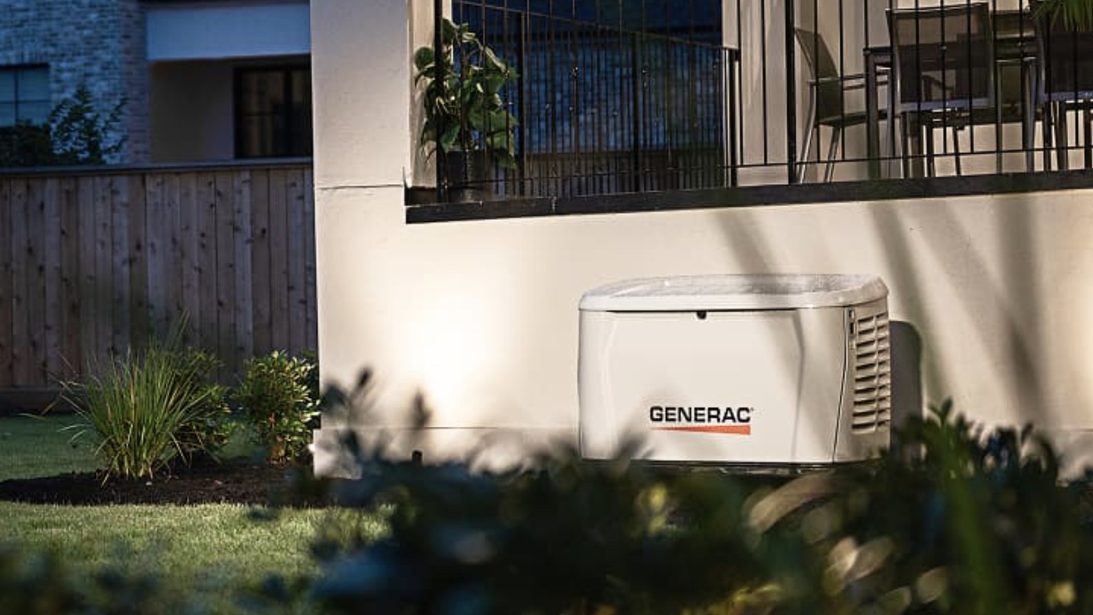 Generac home standby generator installed beside a home at dusk